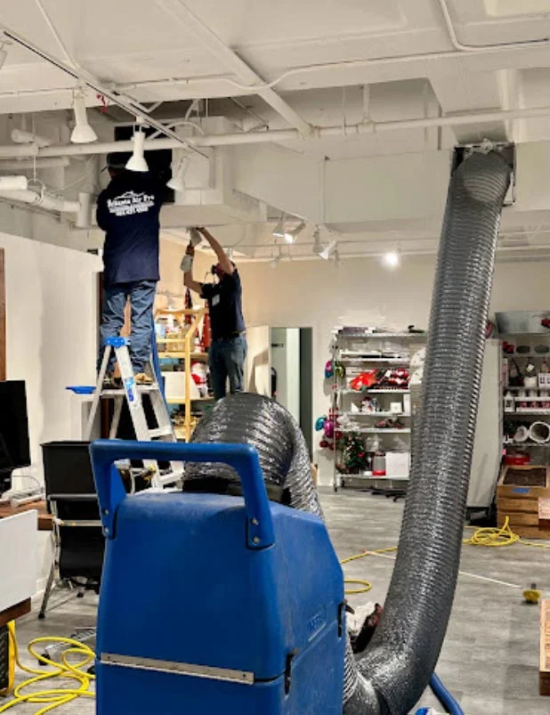 Atlanta Air Pro technicians cleaning air ducts in a commercial office space.