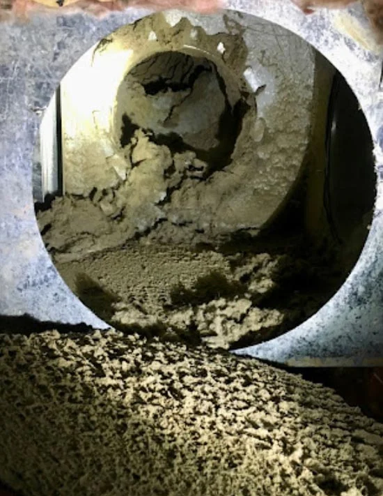 Heavily clogged air duct before cleaning.