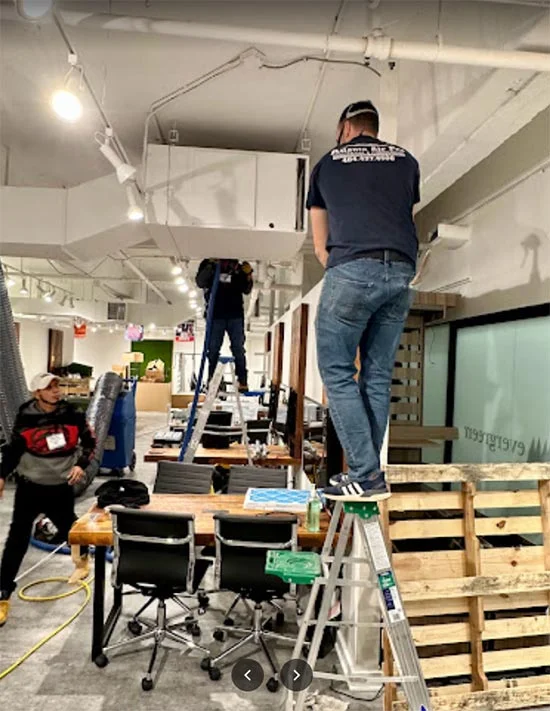 Atlanta Air Pro technicians cleaning air ducts in a commercial property.