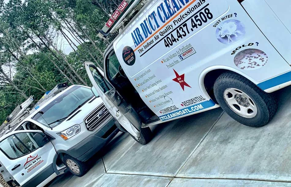 Air Duct Cleaners service vans parked on a driveway